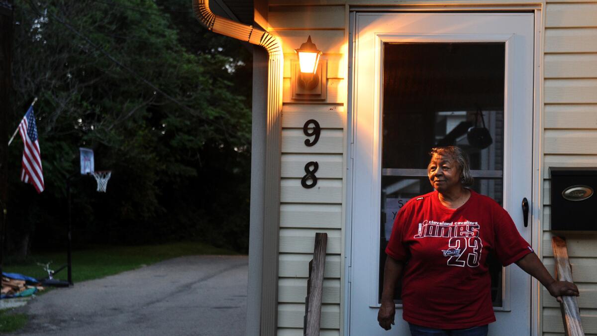 Wanda Reaves stands next to the front door of the home where she once housed LeBron James during his childhood.