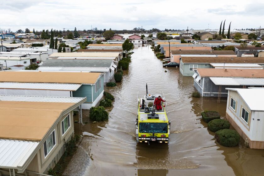 This aerial view shows rescue crews assisting stranded residents in a flooded neighborhood in Merced, California on January 10, 2023. - A massive storm called a bomb cyclone" by meteorologists has arrived and is expected to cause widespread flooding throughout the state. (Photo by JOSH EDELSON / AFP) (Photo by JOSH EDELSON/AFP via Getty Images)