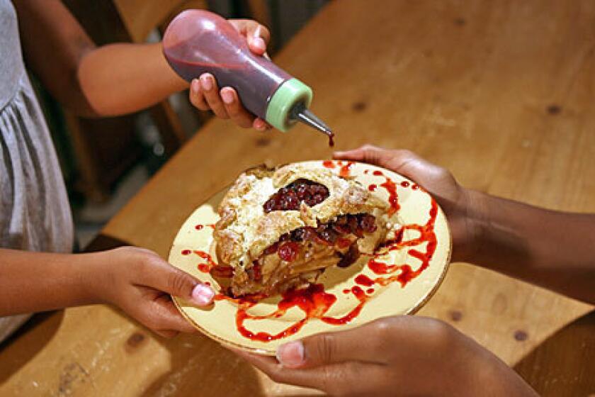 MADE WITH LOVE: Before serving the cranberry-apple pie, let your little helpers make a pretty swirly pattern on the plate.