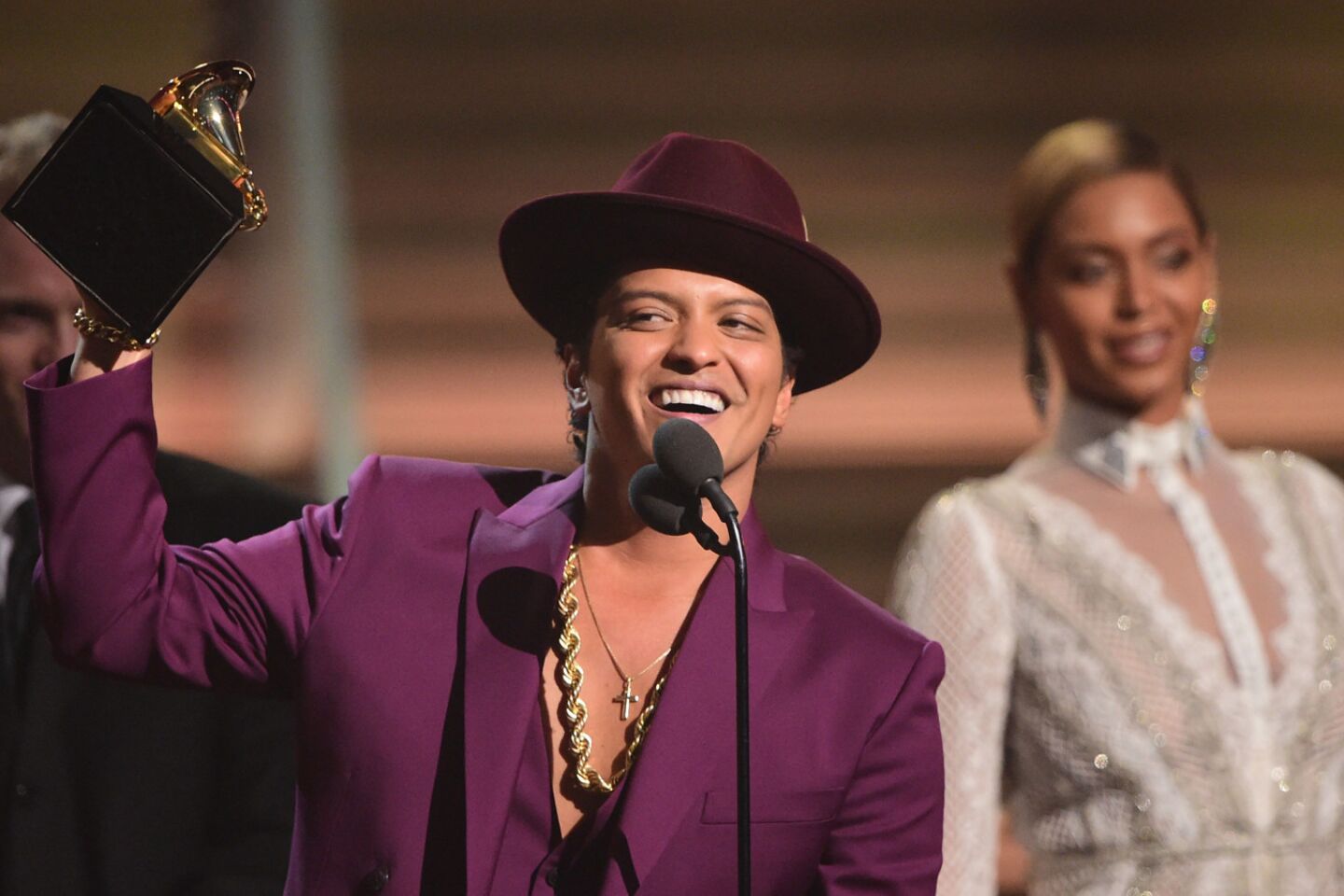 Bruno Mars holds up the award for record of the year for "Uptown Funk" as he thanks the fans.