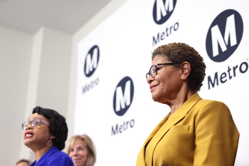 LOS ANGELES-CA-MAY 16, 2024: Los Angeles Mayor Karen Bass, right, stands with Metro leaders including Metro CEO Stephanie Wiggins, left, to introduce a motion to make Metro safer for riders and operators, at Metro Headquarters in Los Angeles on May 16, 2024. (Christina House / Los Angeles Times)