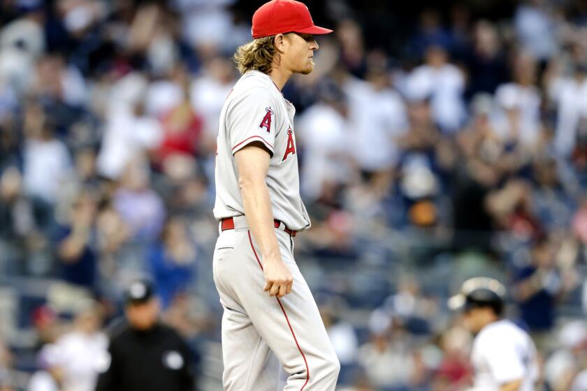 Angels starter Jered Weaver returns to the mound as Yankees infielder Stephen Drew rounds the bases after hitting a two-run home run in the second inning Friday night in New York.