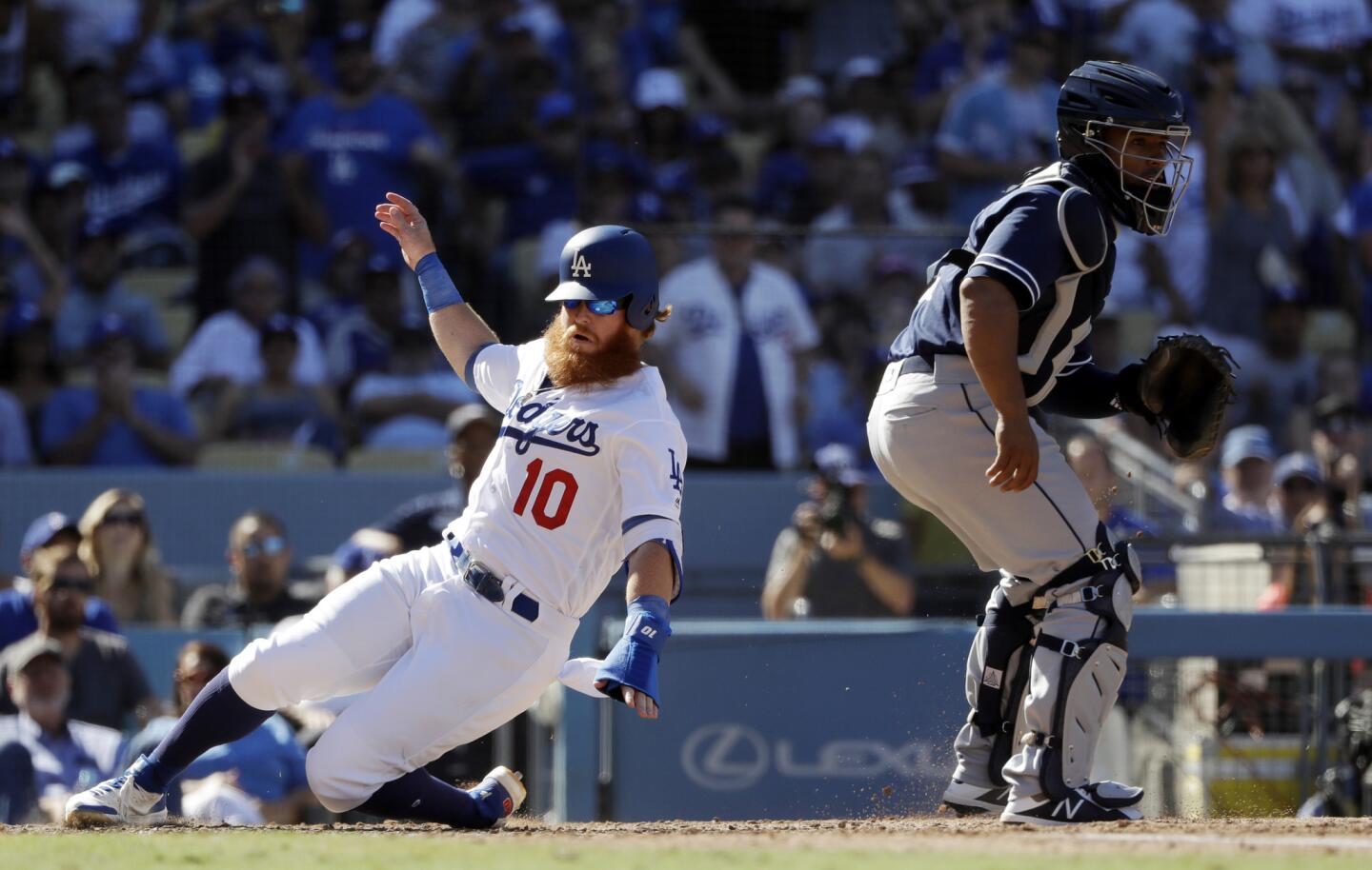Los Angeles Dodgers' Justin Turner (10) scores past San Diego Padres catcher Francisco Mejia after a single by Max Muncy during the fifth inning of a baseball game Sunday, Sept. 23, 2018, in Los Angeles.