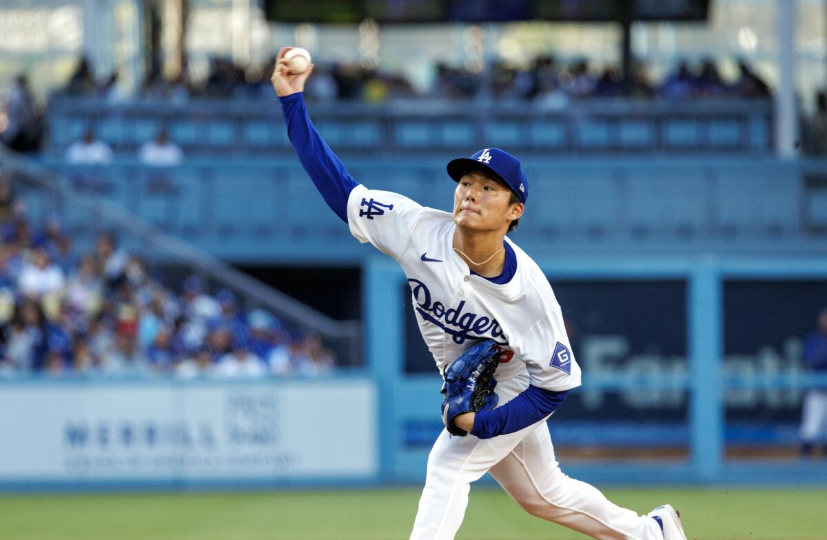 Dodgers starting pitcher Yoshinobu Yamamoto delivers against the Royals on Saturday.