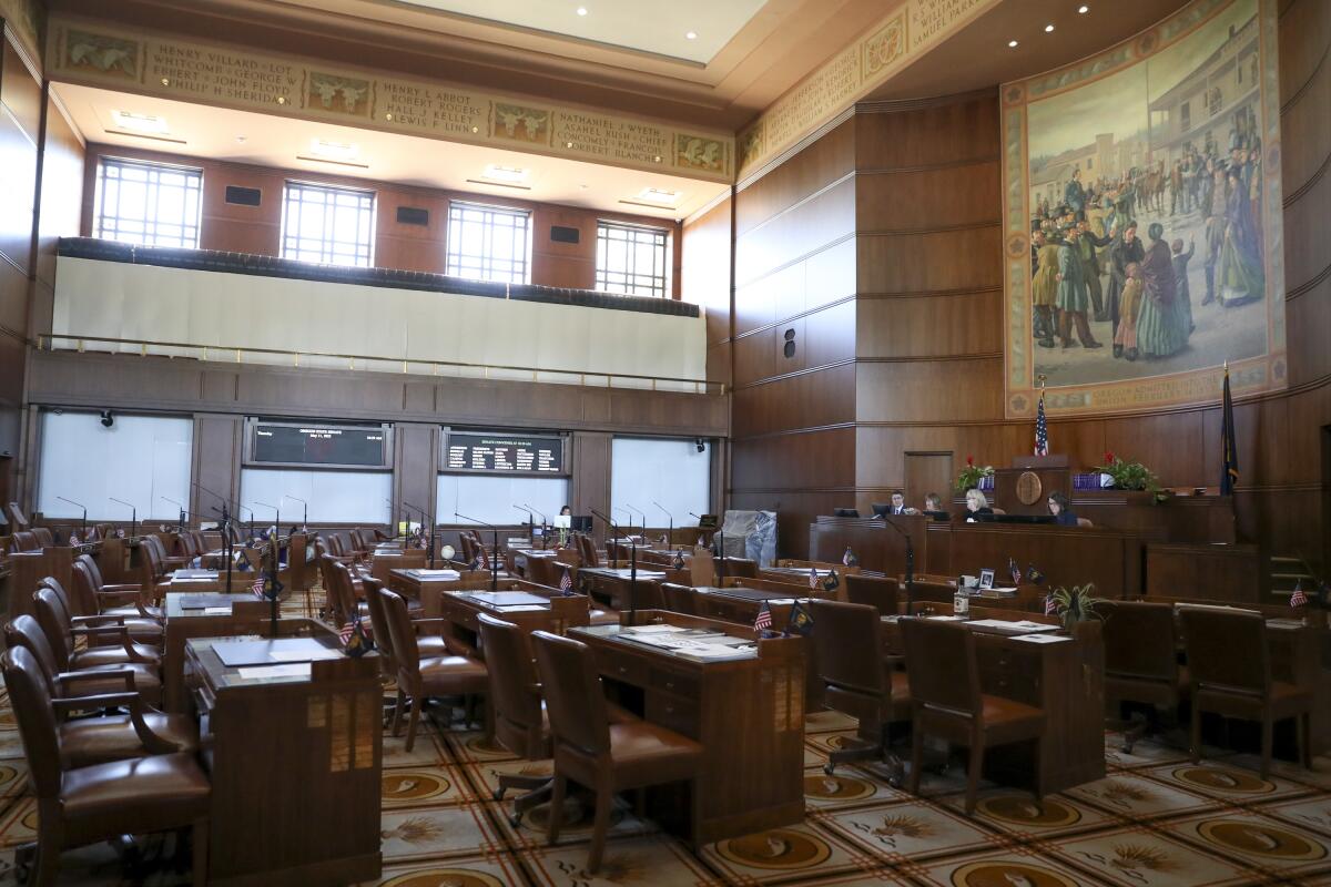 Empty chairs are shown in the Oregon Senate chambers