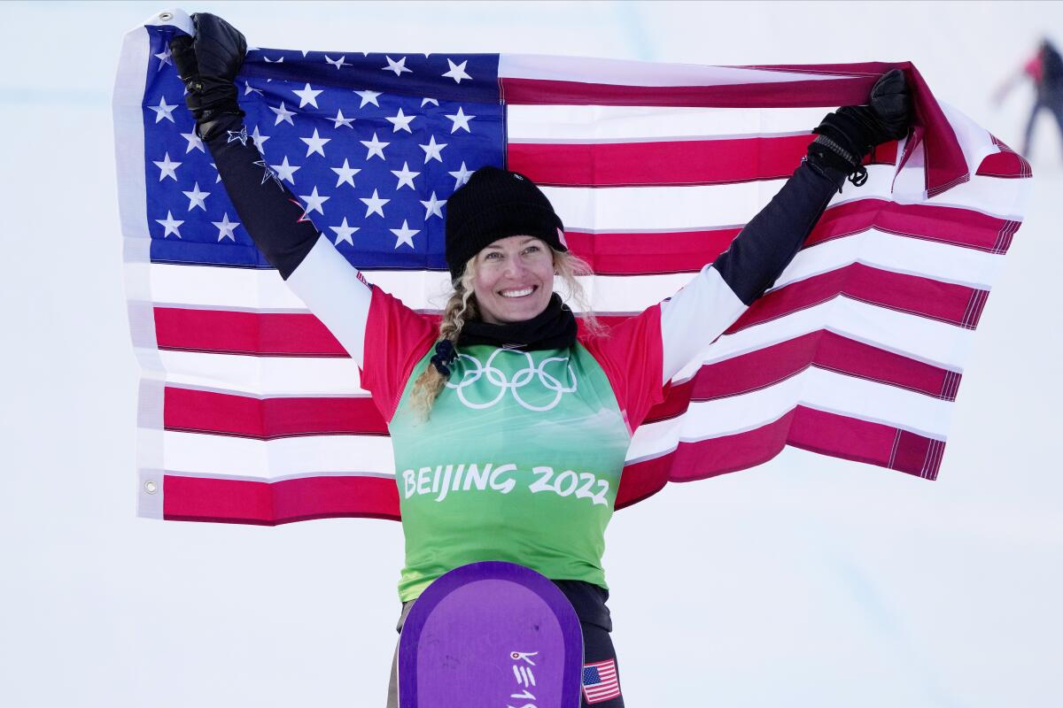  Lindsey Jacobellis smiles and holds a U.S. flag after winning a gold medal in the women's cross finals