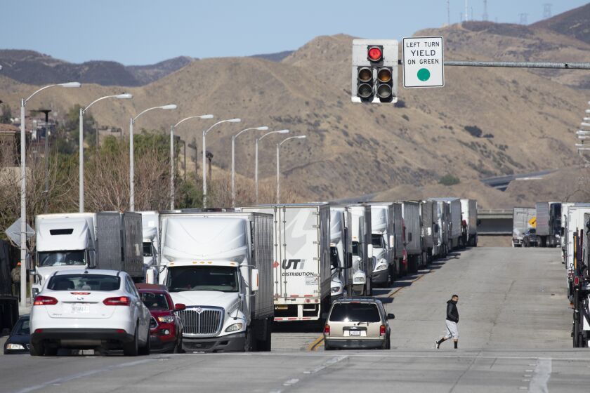 CASTAIC, CA - JANUARY 26: Trucks are parked along Castaic Road in Castaic on Tuesday, Jan. 26, 2021 waiting for Interstate 5 to reopen. A series of winter storms rolling through California has again closed several major highways, including both sides of Interstate 5 near the Grapevine on Tuesday morning. The California Highway Patrol closed the northbound and southbound lanes of the 5 between Castaic and the Grapevine because of heavy snow overnight. It was not immediately clear when the road would reopen. (Myung J. Chun / Los Angeles Times)