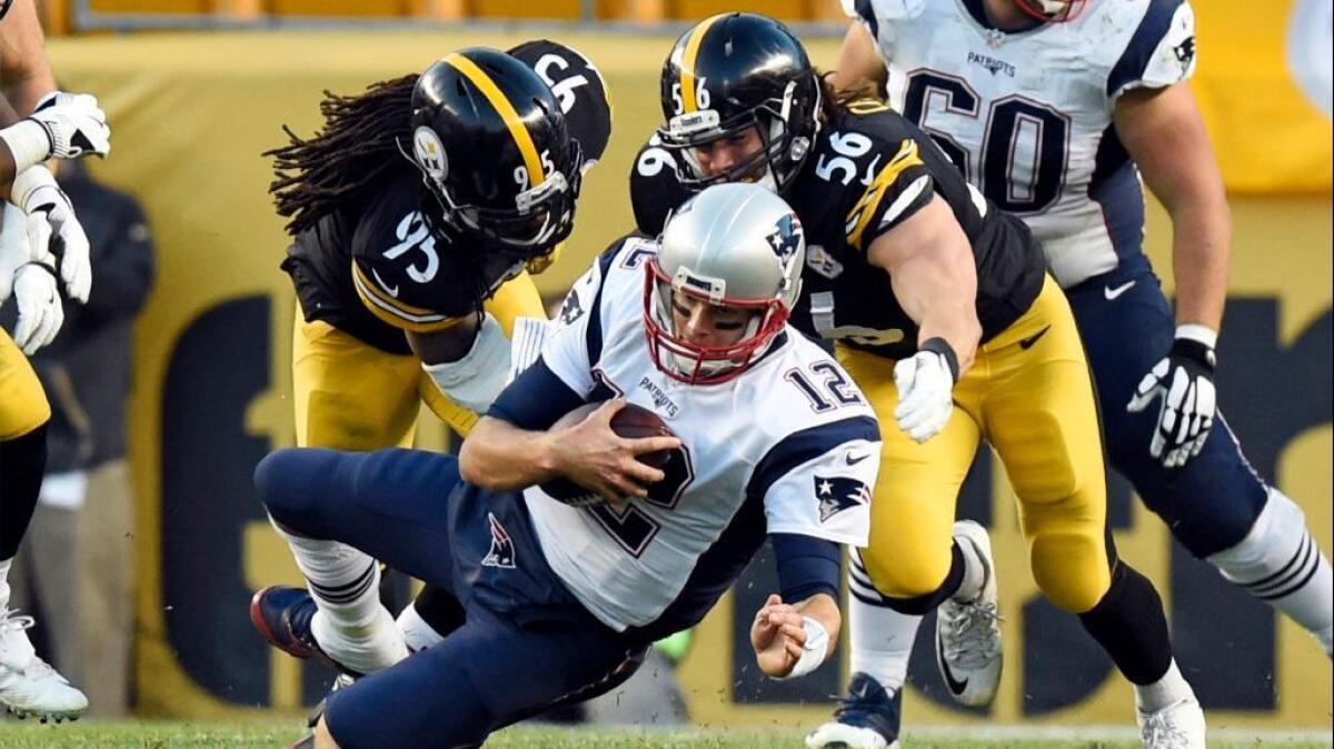Patriots quarterback Tom Brady is sacked by Steelers linebackers Jarvis Jones (95) and Anthony Chickillo (56) during the second half of a game Oct. 23.