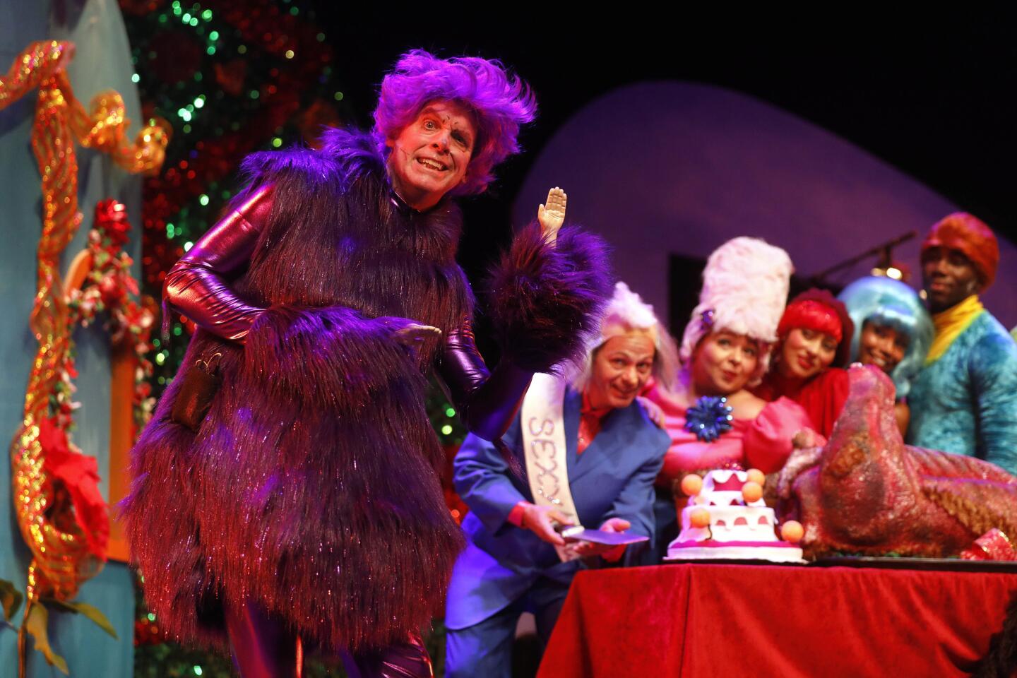 Matt Walker, foreground, portrays the Grinch-meets-Prince character the Princh in Troubadour Theater Company's "How the Princh Stole Christmas!" The wacky tale of a loner at yuletide is performed at the El Portal in North Hollywood.