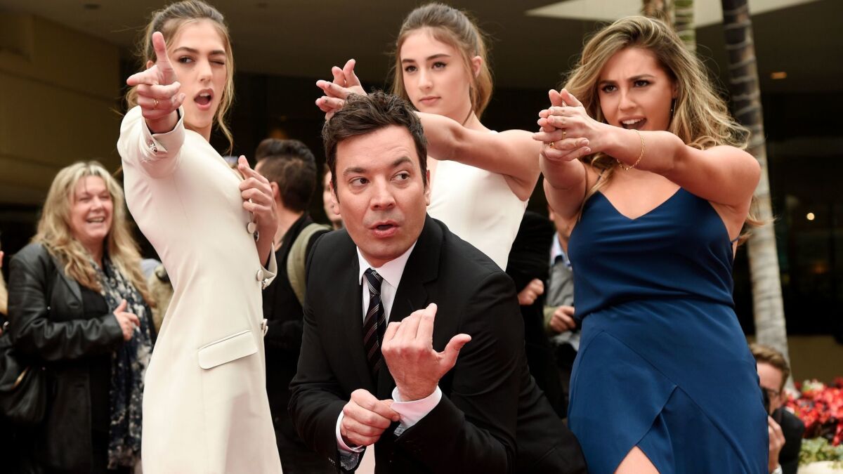 Golden Globe Awards host Jimmy Fallon poses with Miss Golden Globes 2017, from left, sisters Sistine, Scarlet and Sophia Stallone on Wednesday.