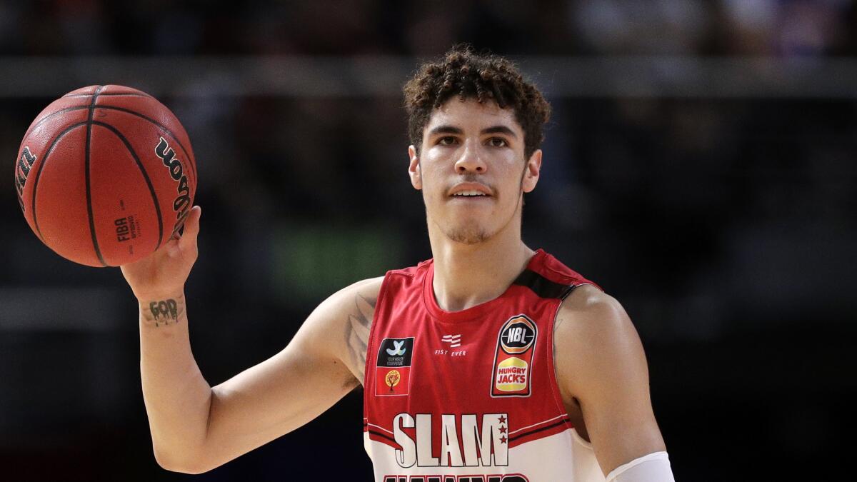 FILE - In this Nov. 17, 2019, file photo, LaMelo Ball of the Illawarra Hawks carries the ball up during their game against the Sydney Kings in the Australian Basketball League in Sydney. LaMelo Ball's bone bruise on his left foot is expected to keep him out of the Illawarra Hawks lineup for the remainder of the National Basketball League season in Australia. The 18-year-old American, who joined Illawarra as part of the NBL's Next Stars program, is expected to be a first-round pick in this year's NBA draft.(AP Photo/Rick Rycroft, File)