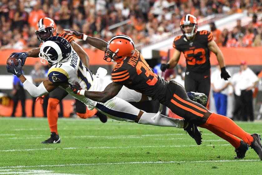 CLEVELAND, OHIO SEPTEMBER 22, 2019-Rams receiver Robert Woods makes a diving catch in front of Browns conrerback Terrance Mitchell in the 2nd quarter at First Energy Stadium in Cleveland Sunday. (Wally Skalij/Los Angeles Times)