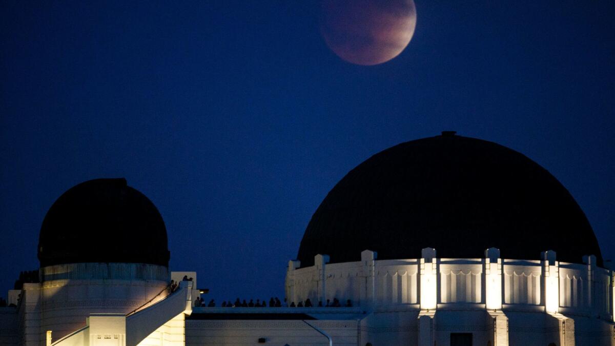 A blood moon rises during a lunar eclipse over the Griffith Observatory on Sept. 27, 2015. A blood moon and full lunar eclipse will occur early Wednesday.