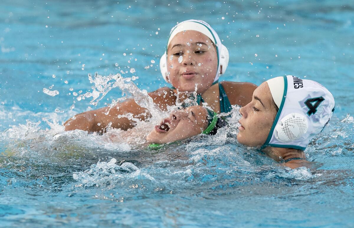 Costa Mesa's Makenzie Mora is surrounded by Aliso Niguel's Reyna Palfreyman and Lexi Van Den Berg, right.
