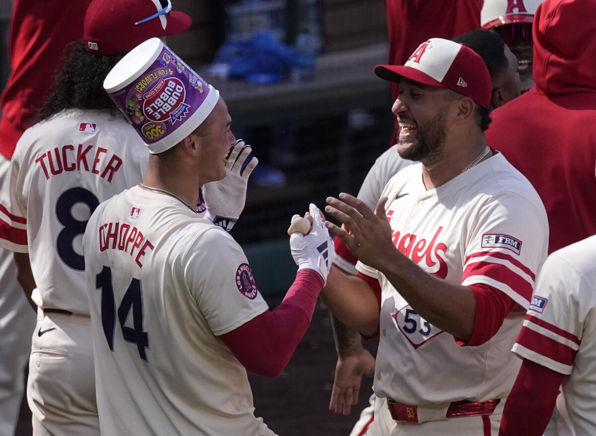 Angels catcher Logan O'Hoppe, left, celebrates with closer Carlos Estévez.