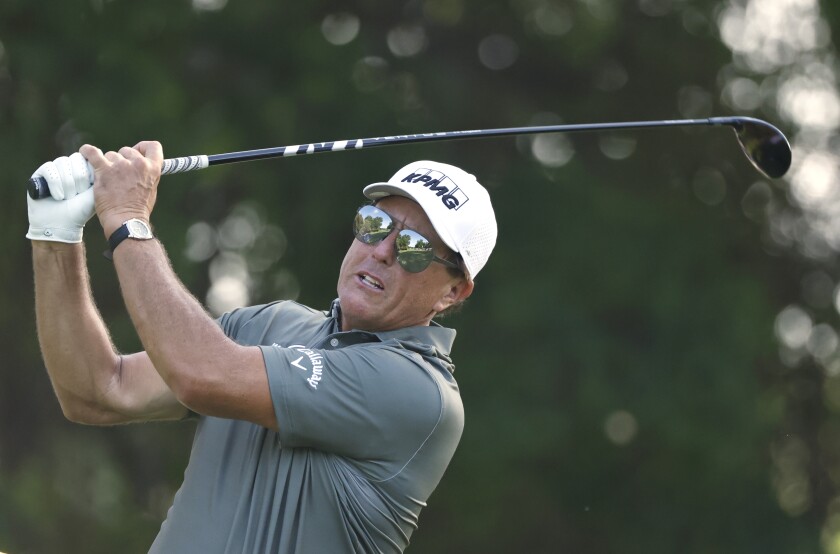 Phil Mickelson plays his shot from the 12th tee during the first round of the Charles Schwab Challenge golf tournament at the Colonial Country Club in Fort Worth, Texas, Thursday, May 27, 2021. (AP Photo/Ron Jenkins)