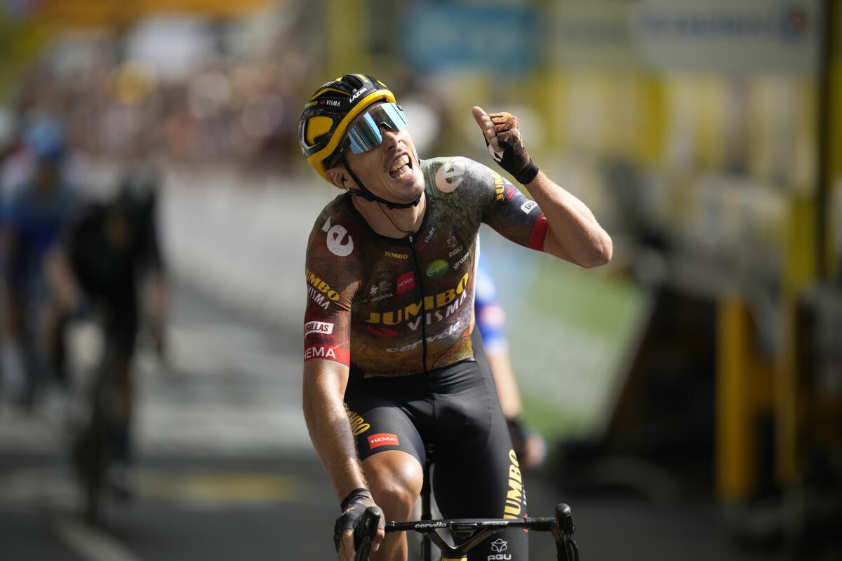 France's Christophe Laporte celebrates as he crosses the finish line to win the nineteenth stage of the Tour de France cycling race over 188.5 kilometers (117.3 miles) with start in Castelnau-Magnoac and finish in Cahors, France, Friday, July 22, 2022. (AP Photo/Daniel Cole)