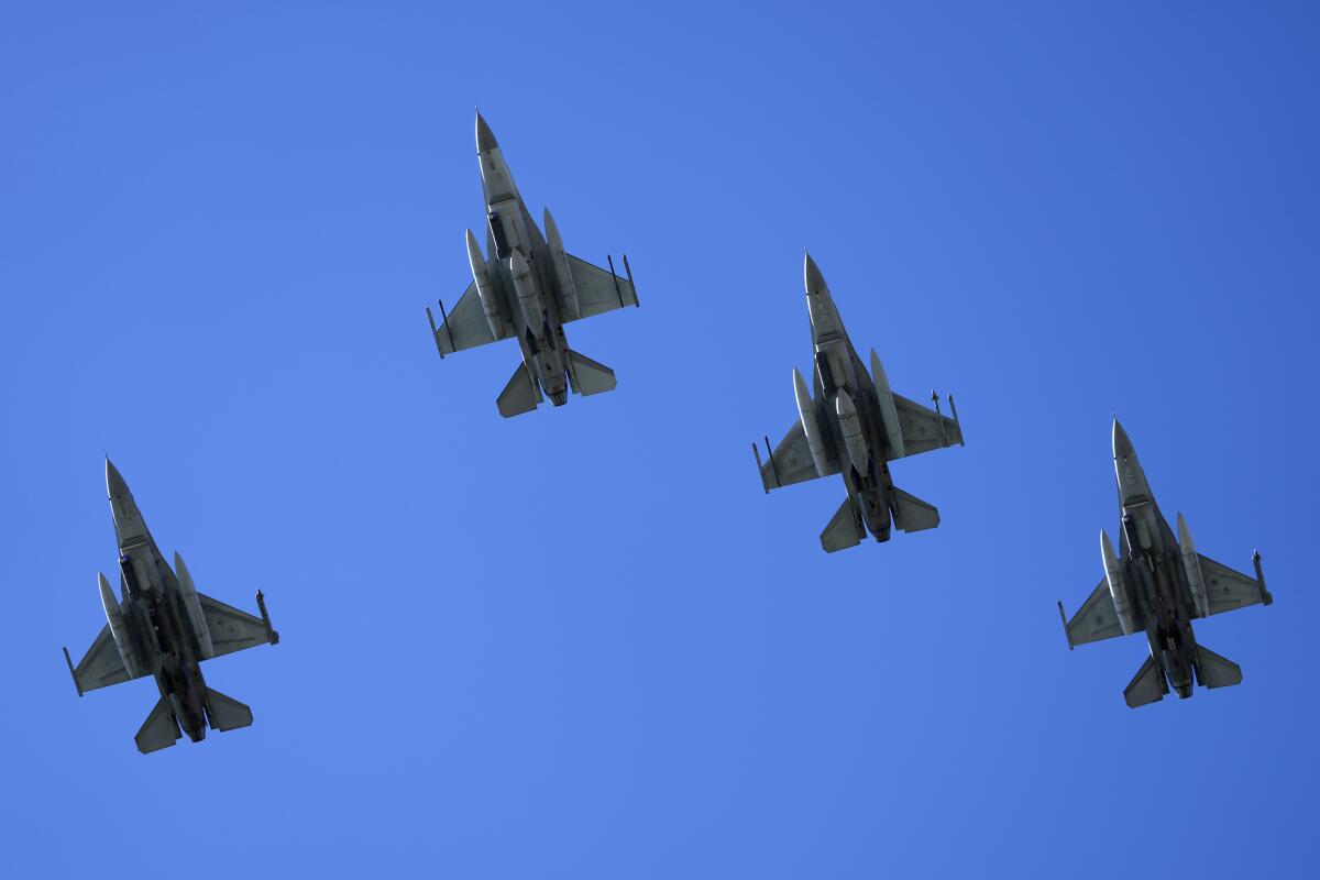 Four F-16s flying in formation seen from below