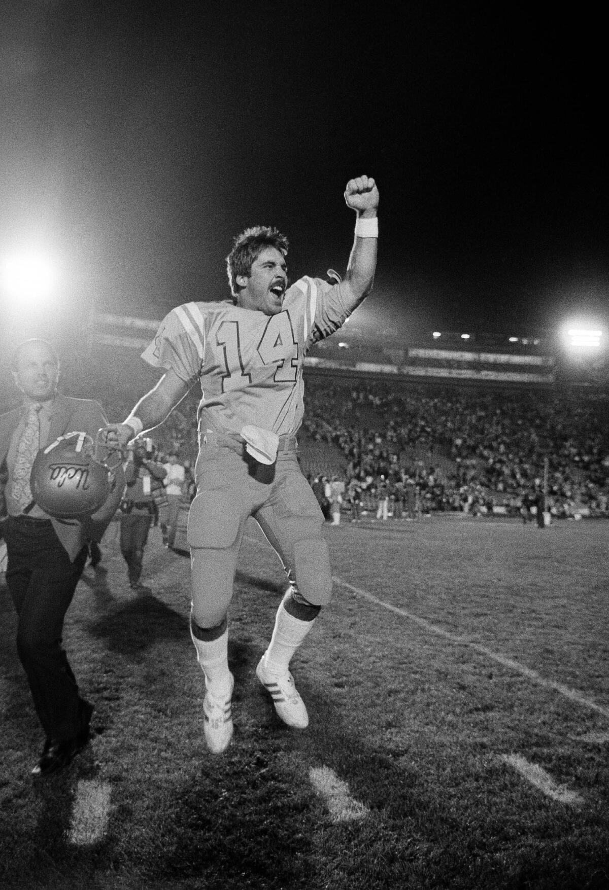 UCLA quarterback Tom Ramsey jumps for joy after leading his teammates to victory over Michigan in the 1983 Rose Bowl game.