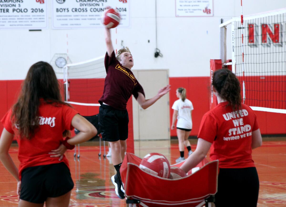 Real's Youth Volleyball Camp participant Braden Turner, 12, goes up for a spike, at Burbank High School in Burbank on Thursday, July 28, 2019. The camp is set in two gyms, one for children ages 11-4 and the other for those 8-10.