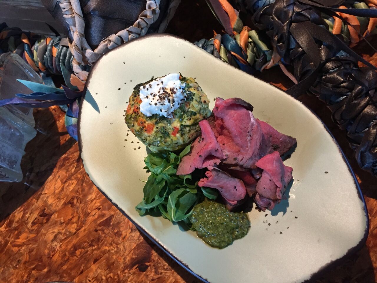 Satu'li Canteen, a restaurant within Pandora, includes vegetable-goat cheese fritatta with wood-fired, herb-crusted beef and chimichurri on its breakfast menu.