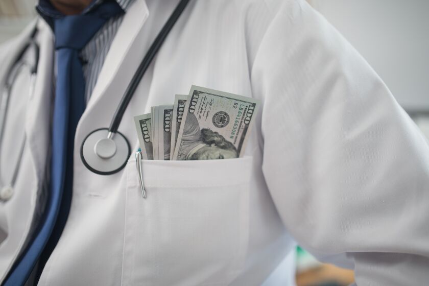 Corrupt doctor with money in his pocket