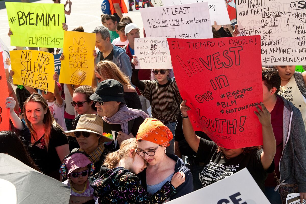 Demonstrators rally at the March for Our Lives in Santa Ana on Saturday.