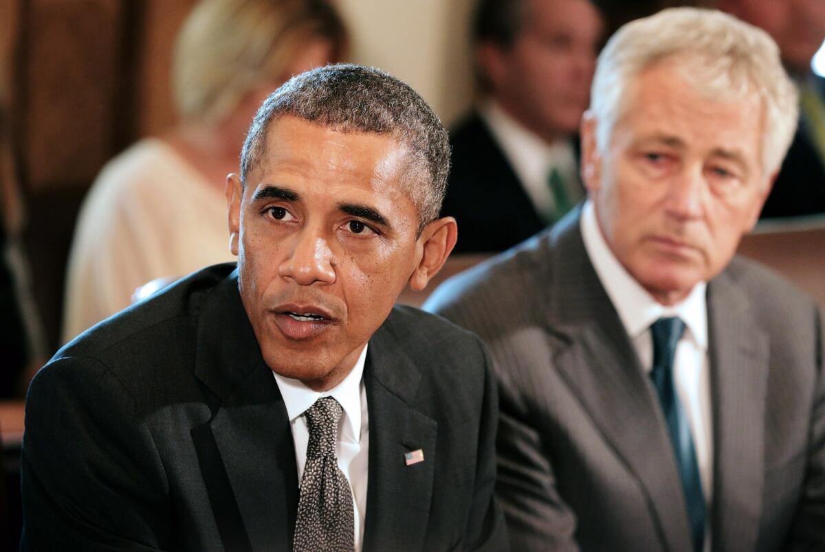 President Obama is seen during a cabinet meeting with Defense Secretary Chuck Hagel in the Cabinet Room of the White House.