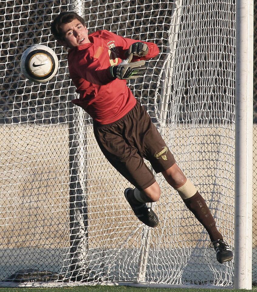 St. Francis goalie Mark Garcia blocks a shot by Loyola during a game at Loyola High on Friday, January 17, 2014.