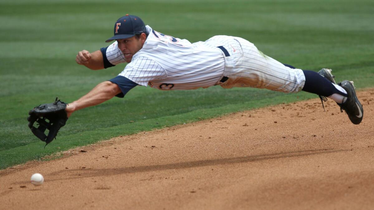Cal State Fullerton shortstop Timmy Richards dives for the ball against Long Beach State on June 10.