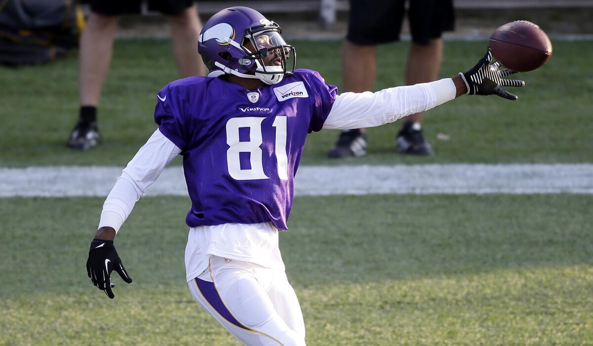 Vikings receiver Jerome Simpson reaches for a pass during summer camp.