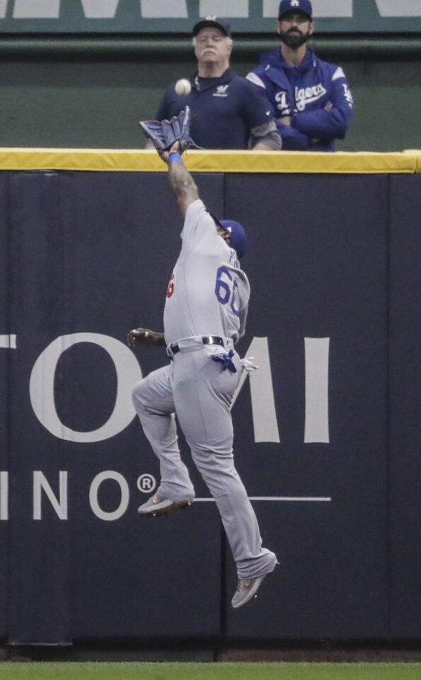 Yasiel Puig misses a fourth inning double by Brewers second baseman Travis Shaw.