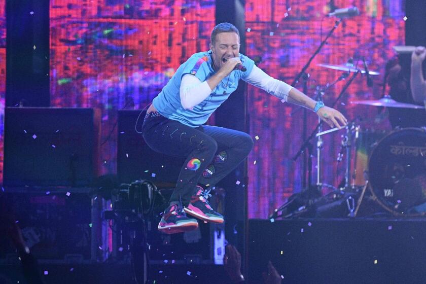 Chris Martin of Coldplay performs with the Chainsmokers during Wednesday's Brit Awards in London.