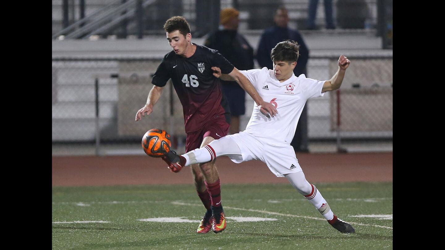 Estancia's Gerrardo Leon, 6, and Laguna's John Ford, try to gain control of a ball in boys varsity soccer action against on Tuesday.