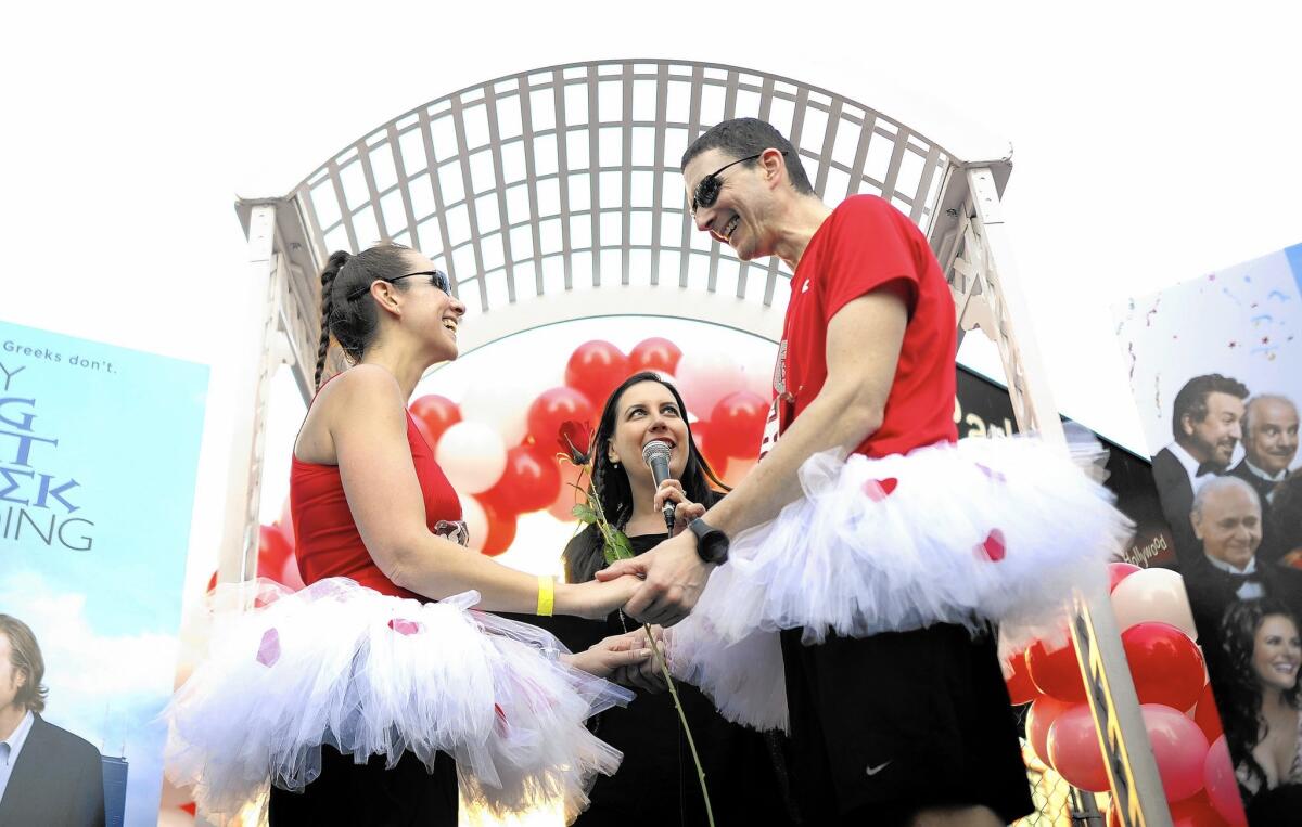 Neal and Barbara Dannenberg of New York take a break from running to renew their wedding vows during the L.A. Marathon, which coincided with Valentine's Day for the first time.