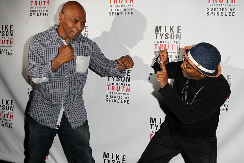Mike Tyson, left, and director Spike Lee kid around backstage at a "Mike Tyson: Undisputed Truth" event last summer.