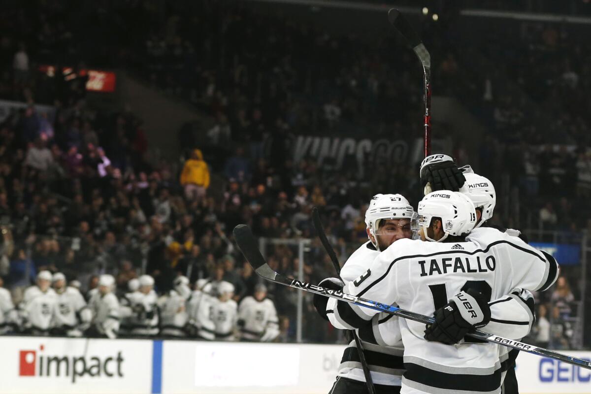 Kings' Alec Martinez (27), Jake Muzzin (6), and Alex Iafallo (19) celebrate Martinez's goal during the third period at Staples Center on Dec. 02, 2018.