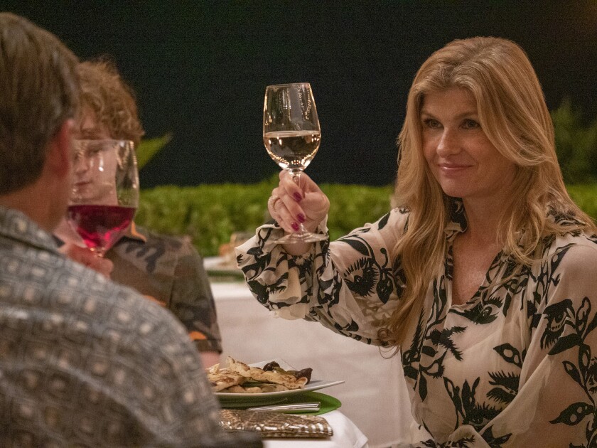 Connie Britton raises a glass in the HBO series "The White Lotus.”