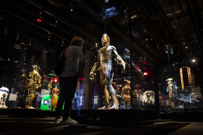Los Angeles, CA - September 21: The prosthetic suit worn by actor Doug Jones as the amphibian man in 2018 Oscar-winning film, "Shape of Water," by director Guillermo del Toro, center, is part of the Stories of Cinema exhibit, a multi-room experience entitled "Inventing Worlds & Characters," including, "Encounters," with some of film's most popular creations, photographed at the Academy Museum of Motion Pictures, in Los Angeles, CA, Tuesday, Sept. 21, 2021. (Jay L. Clendenin / Los Angeles Times)