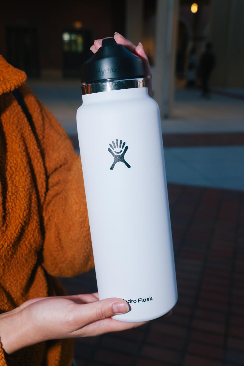 Leslie Compean poses for a portrait with a Hydro Flask branded water bottle