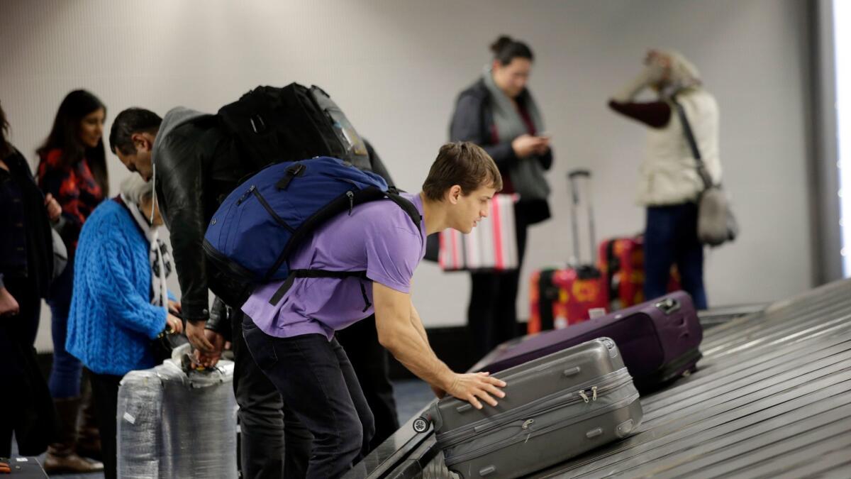 A traveler gathers his luggage at the San Francisco International Airport on Nov. 22, 2015.
