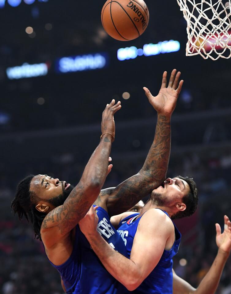 Clippers Danilo Gallinari gets an elbow to the face from teamate DeAndre Jordan while battling for a rebound against the Pacers at the Staples Center.