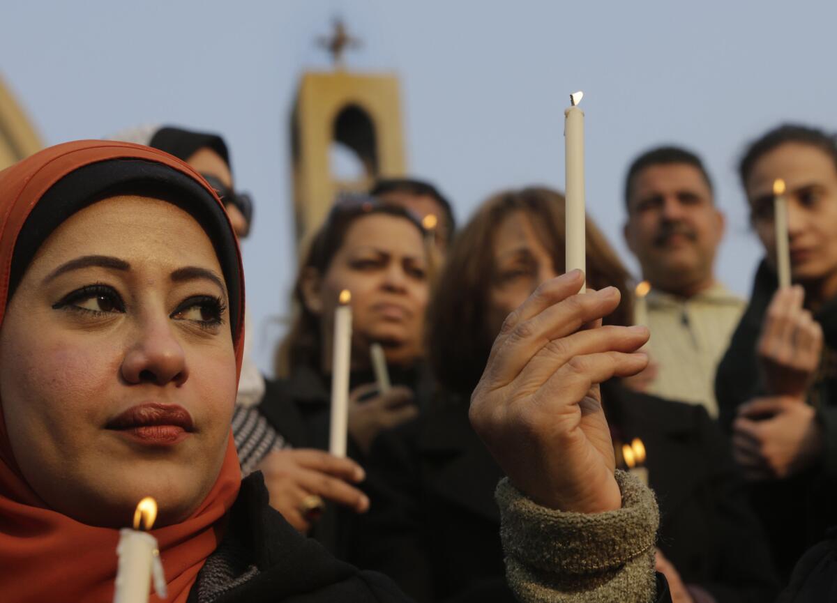 Egyptians at St. Mark's Cathedral in Cairo light candles during a vigil for Christians who were killed in Libya.