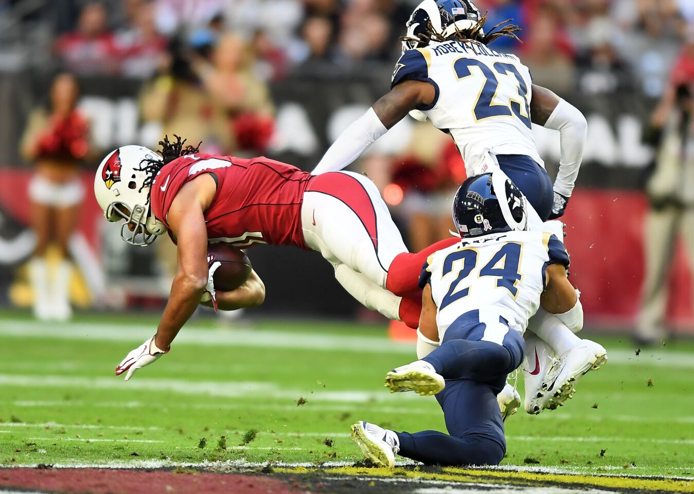 Arizona Cardinals receiver Larry Fitzgerald is tackled by Rams safety Taylor Rapp.