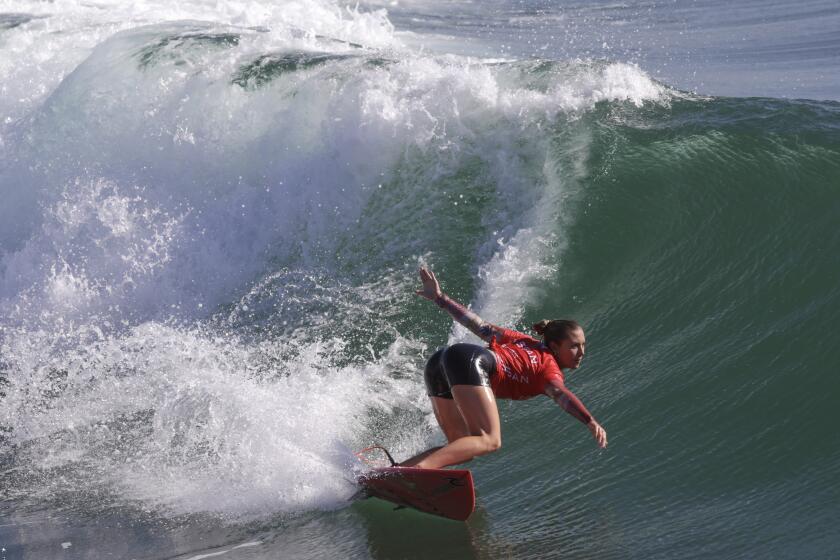 OCEANSIDE, CA - SEPTEMBER 24, 2023: Alyssa Spencer, 20, of Encinitas carves a bottom turn while competing in the final of the Nissan Super Girl Surf Pro surf contest at the Oceanside Pier in Oceanside on Sunday, September 24, 2023. (Hayne Palmour IV / For The San Diego Union-Tribune)