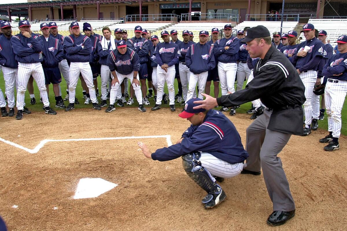 Feb. 28, 2001: Umpire Ted Barrett talks to the Anaheim Angels about the high strike zone at Tempe Diablo Stadium in Tempe, Ariz. The Angels catcher is Kevin Lidle.