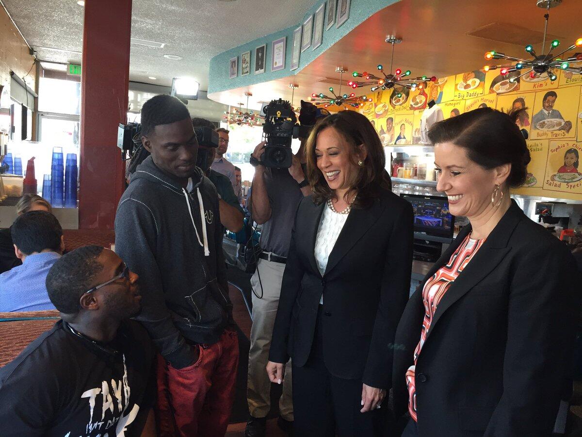U.S. Senate candidate Kamala Harris, center, and Oakland Mayor Libby Schaaf chat with diners at the Home of Chicken and Waffles.