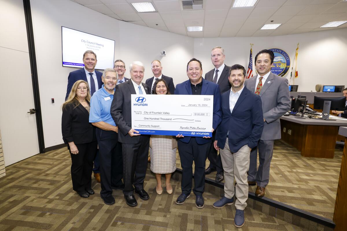 Hyundai representatives present a donation at the Fountain Valley City Council meeting on Tuesday.