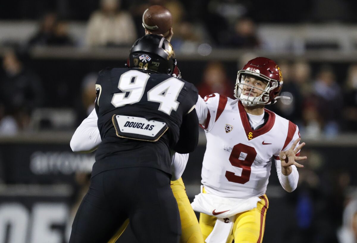USC quarterback Kedon Slovis throws a pass over Colorado defensive tackle Janaz Jordan on Oct. 25, 2019, in Boulder, Colo.