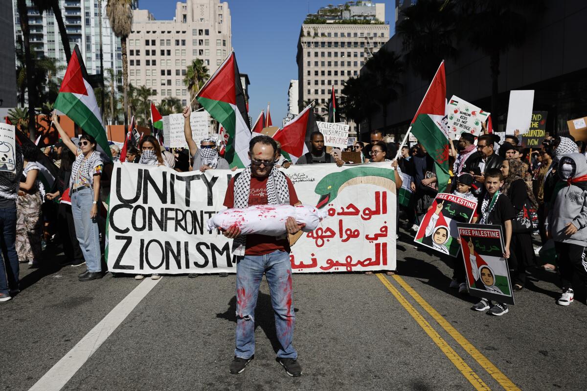 People show their support for the Palestinians during a march in downtown Los Angeles on Oct. 28. 